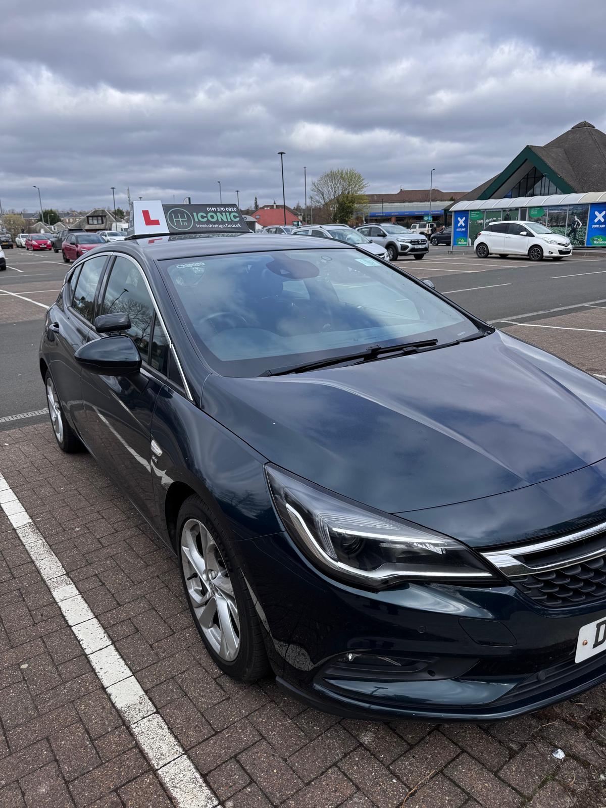 driving school car with learner plate parked in Glasgow car park for driving lessons
