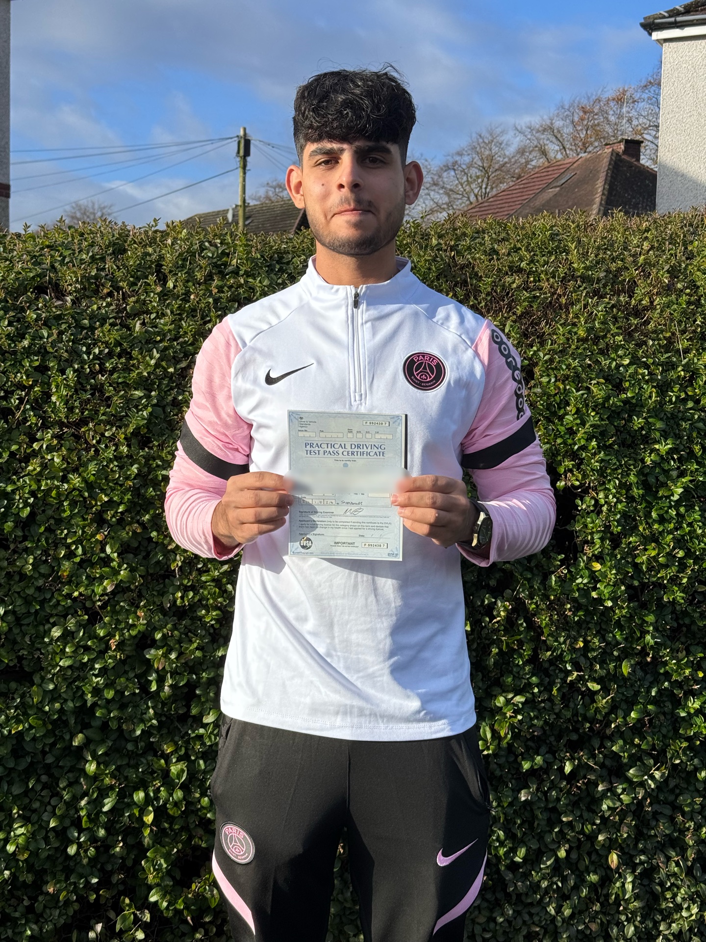 student holding driving test pass certificate after passing driving test in Glasgow