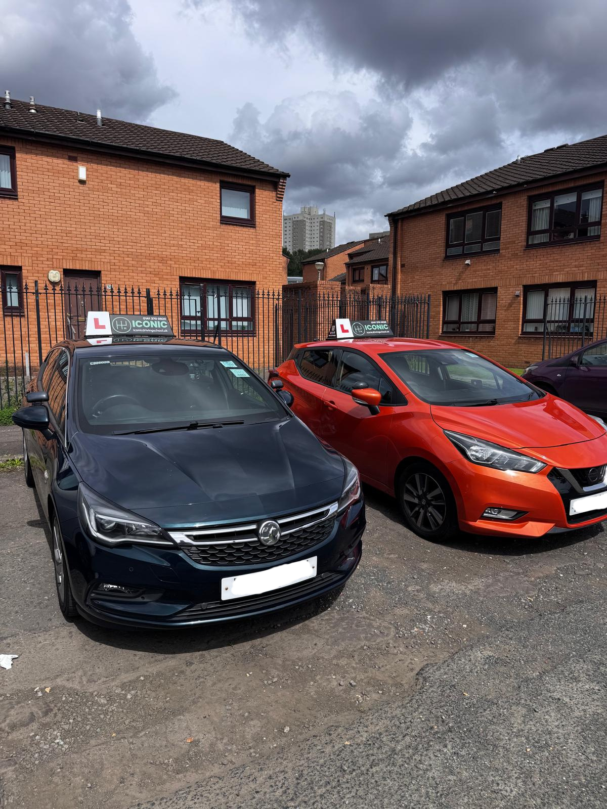 driving school cars with learner plates parked in Glasgow residential area